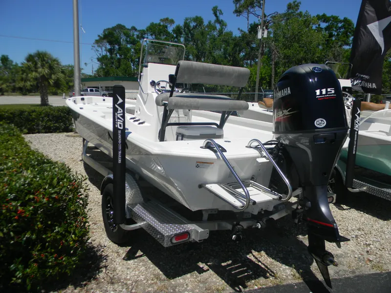 Slide: The Image of 2024 Avid 21 Mag boat with Yamaha 115 outboard motor, parked on a trailer. - 9