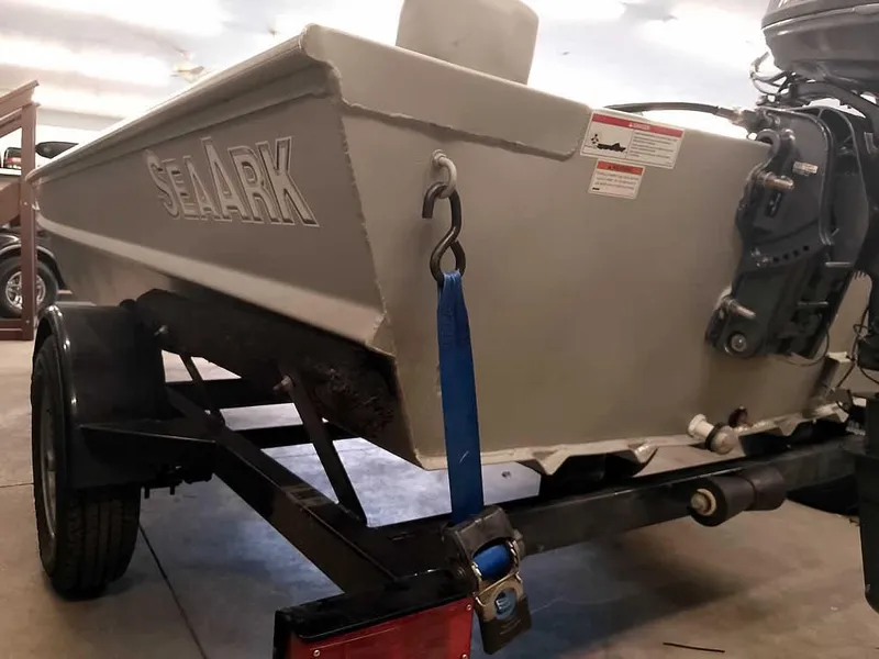 Slide: The Image of 2024 SeaArk 1652 Crappie boat on trailer, rear view with motor. - 10