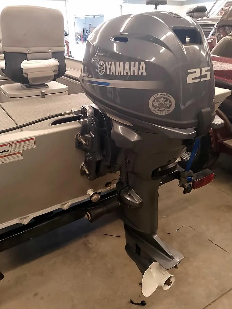 Slide: The Image of 2024 SeaArk 1652 Crappie boat with Yamaha 25 outboard motor in a garage setting. - 11
