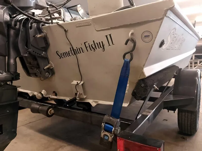 Slide: The Image of 2024 SeaArk 1652 Crappie boat on trailer, named "Somethin Fishy II". - 13