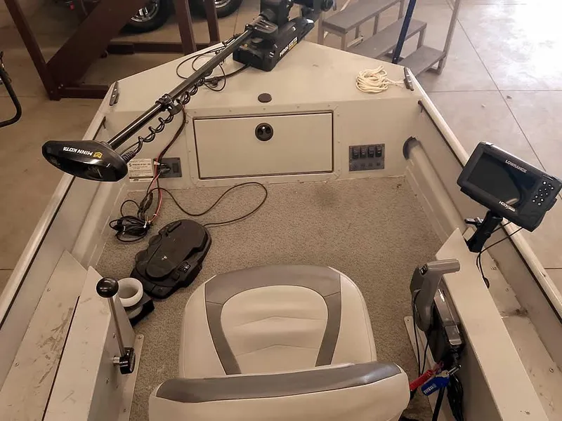 Slide: The Image of 2024 SeaArk 1652 Crappie boat interior with fishing equipment and seating. - 16