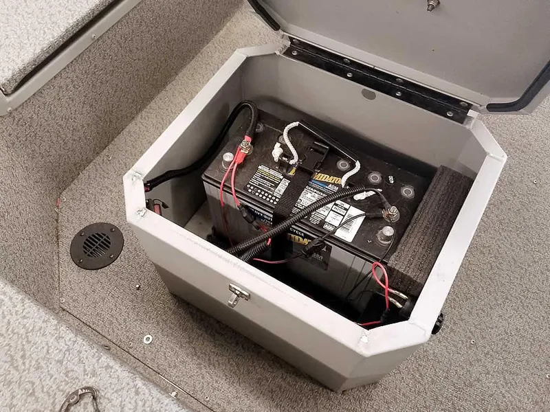 Slide: The Image of Battery compartment in 2024 SeaArk 1652 Crappie boat, showcasing wiring and secure storage. - 23