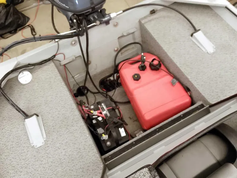 Slide: The Image of 2024 SeaArk 1652 Crappie boat interior showing fuel tank and battery setup. - 24