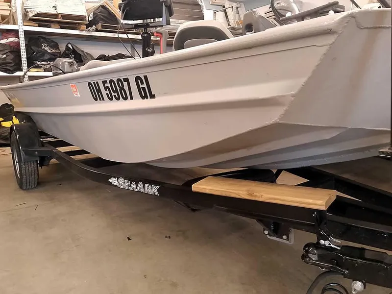 Slide: The Image of 2024 SeaArk 1652 Crappie boat on trailer in garage setting. - 3