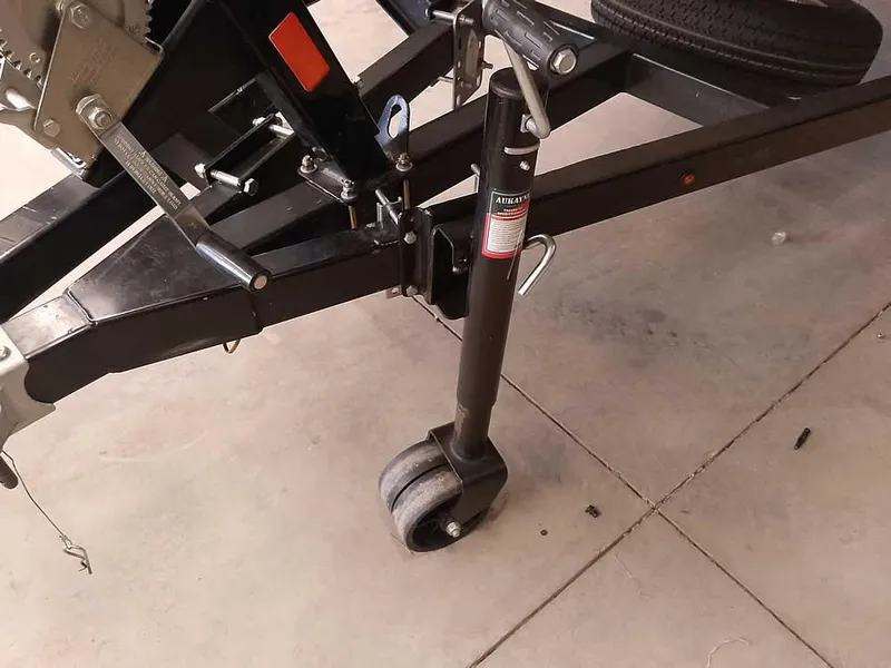 Slide: The Image of Trailer jack and wheel for 2024 SeaArk 1652 Crappie boat on concrete surface. - 5