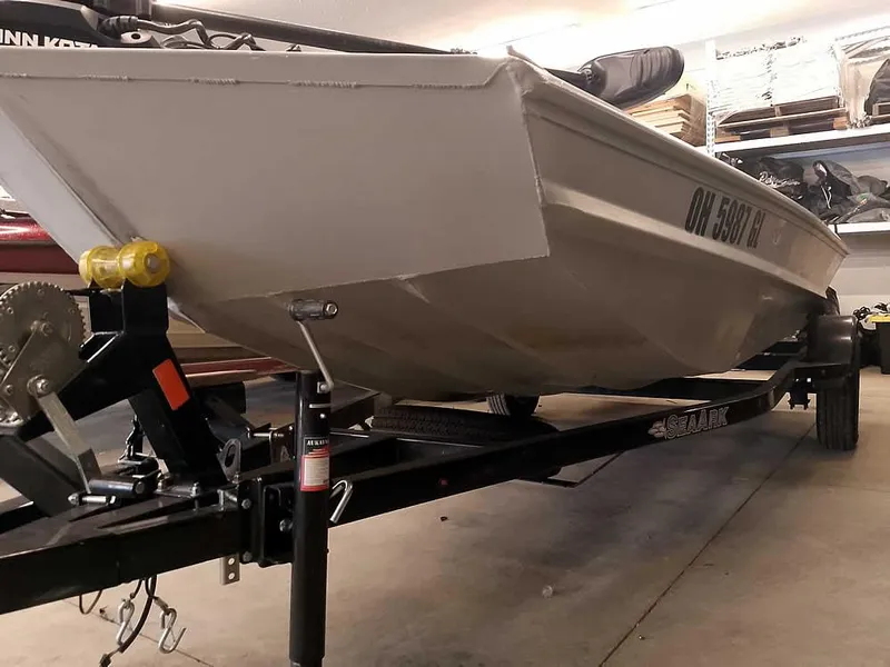 Slide: The Image of 2024 SeaArk 1652 Crappie boat on trailer in a garage setting. - 6