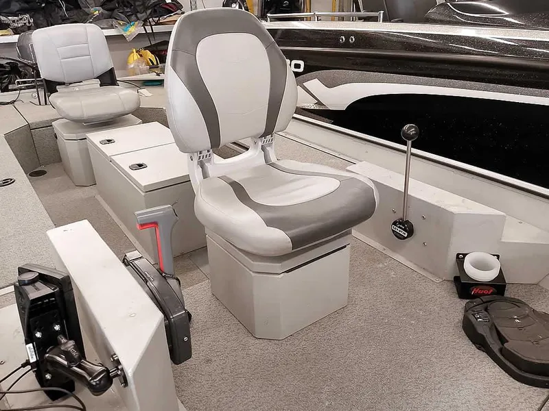 Slide: The Image of 2024 SeaArk 1652 Crappie boat interior with gray seating and control panel. - 9
