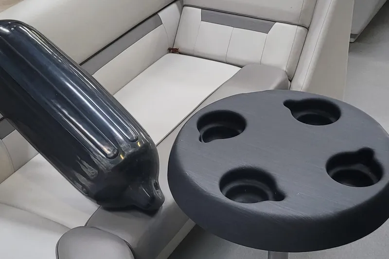 Slide: The Image of Interior of 2022 Godfrey Sweetwater SW2086 with cup holder and black fender on seat. - 11