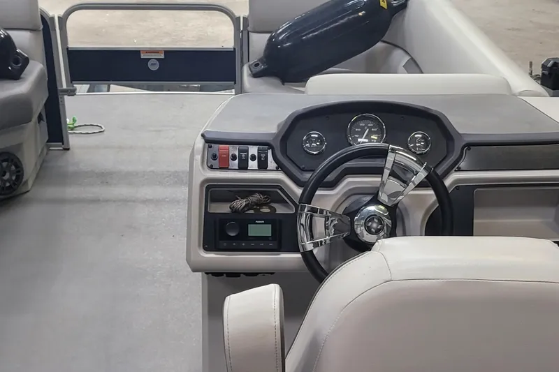 Slide: The Image of 2022 Godfrey Sweetwater SW2086 boat interior with steering wheel and dashboard controls. - 12