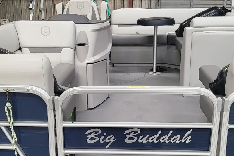 Slide: The Image of 2022 Godfrey Sweetwater SW2086 pontoon boat interior with seating and table, named "Big Buddah." - 9