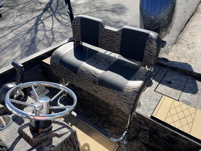 Slide: The Image of 2025 Xpress H210B boat interior with patterned seating and steering wheel. - 10