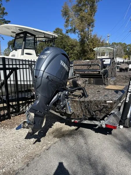 Slide: The Image of 2025 Xpress H210B boat with Yamaha 150 outboard motor, parked outdoors. - 3