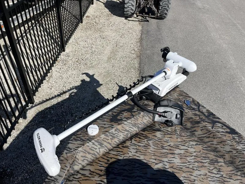 Slide: The Image of 2025 Xpress H210B boat with Minn Kota trolling motor on patterned deck. - 6