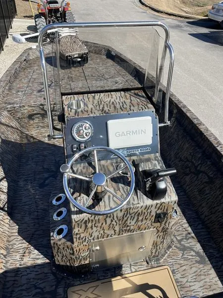 Slide: The Image of 2025 Xpress H210B boat with Garmin navigation, camo design, and steering console. - 7