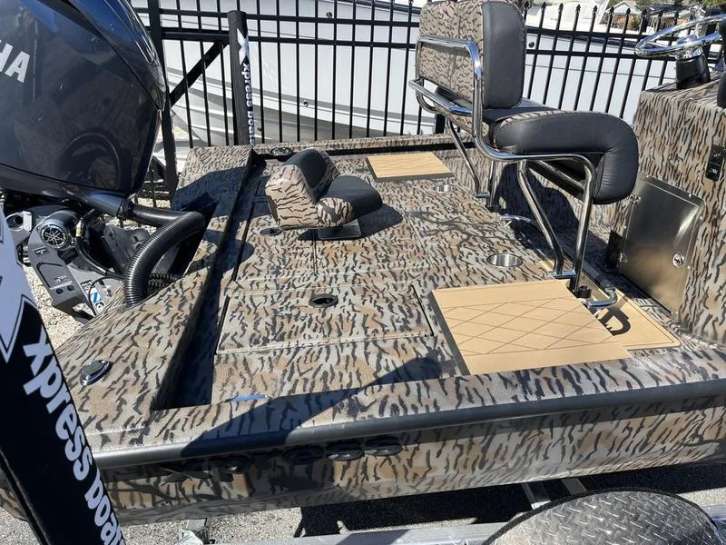 Slide: The Image of 2025 Xpress H210B boat with camouflage design and Yamaha engine, featuring seating and storage. - 9