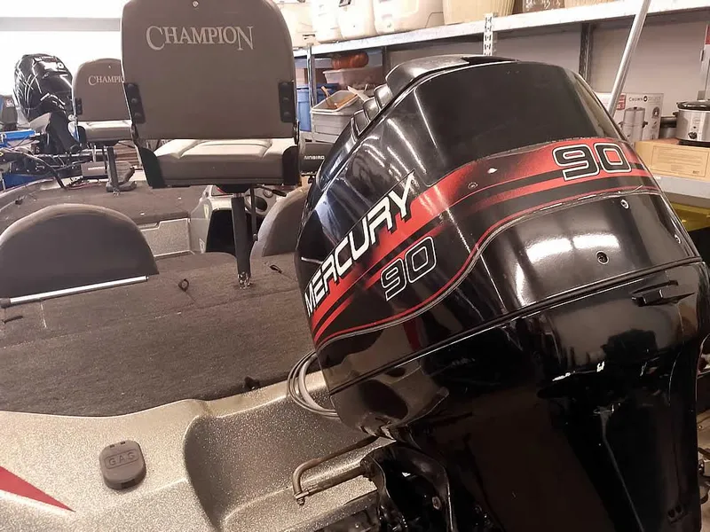 Slide: The Image of Champion 171 boat with Mercury 90 outboard motor, 1999 model, in a storage area. - 1