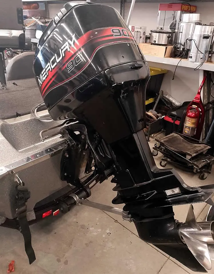 Slide: The Image of Outboard motor on a Champion 171 boat, 1999 model, in a workshop setting. - 10