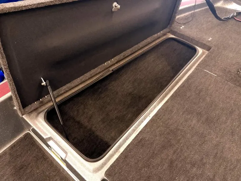 Slide: The Image of Open storage compartment in a 1999 Champion 171 boat. - 17