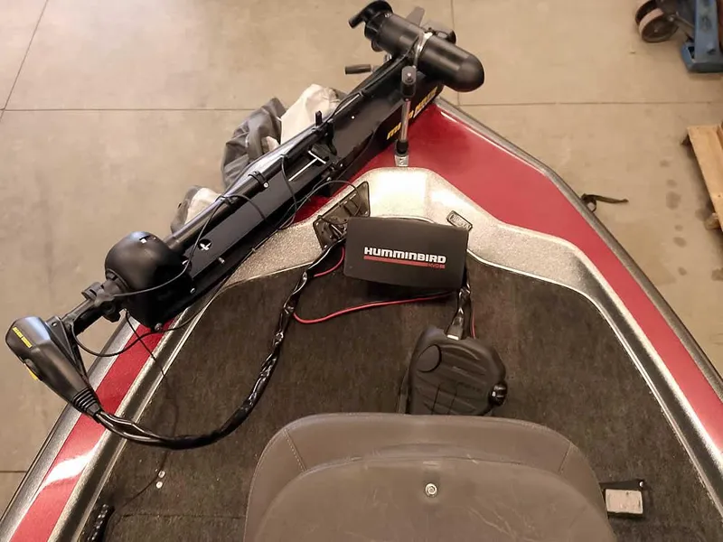 Slide: The Image of 1999 Champion 171 boat with Humminbird fish finder and trolling motor on deck. - 19