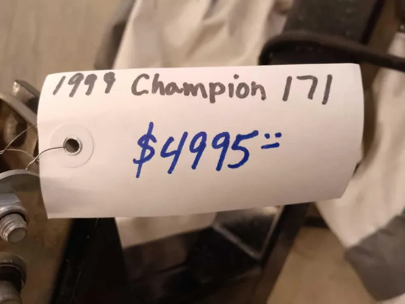 Slide: The Image of 1999 Champion 171 price tag, $4995, handwritten on white paper. - 2