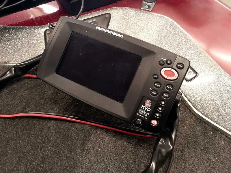 Slide: The Image of Fishfinder device on a Champion 171 boat, 1999 model, with control buttons and display screen. - 20