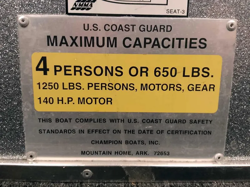 Slide: The Image of U.S. Coast Guard capacity plate for Champion 171, 1999: 4 persons or 650 lbs, 140 HP motor. - 23