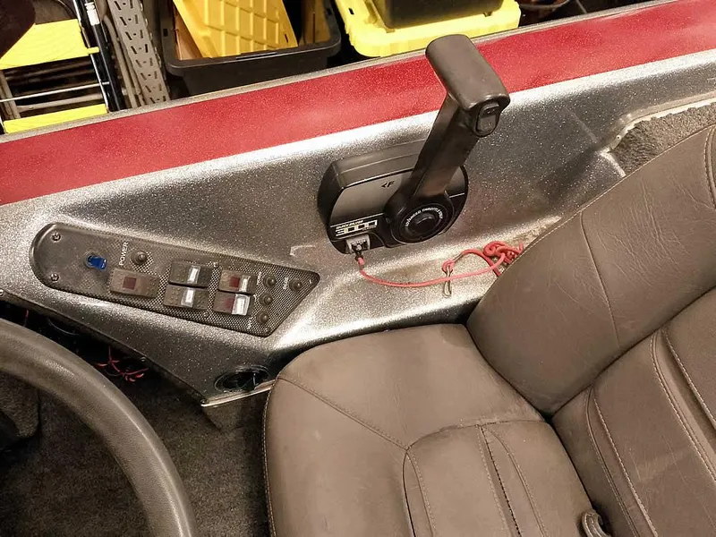 Slide: The Image of Interior of a 1999 Champion 171 boat with control panel and seat. - 25