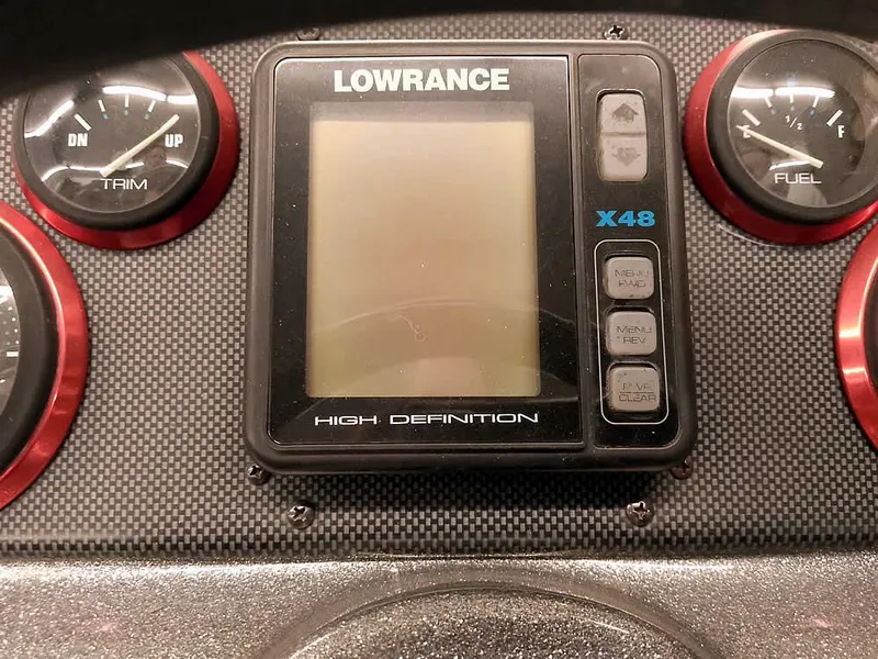 Slide: The Image of Dashboard of a 1999 Champion 171 boat with Lowrance X48 display and gauges. - 26