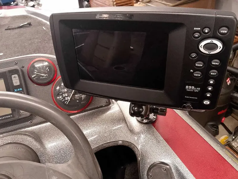 Slide: The Image of Dashboard of a 1999 Champion 171 boat with fishfinder and gauges. - 27