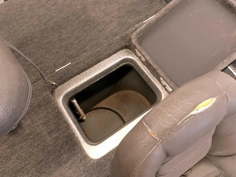 Slide: The Image of 1999 Champion 171 boat storage compartment with open lid, showing interior space. - 29