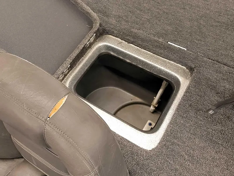 Slide: The Image of 1999 Champion 171 boat storage compartment with gray upholstery and carpeted interior. - 30