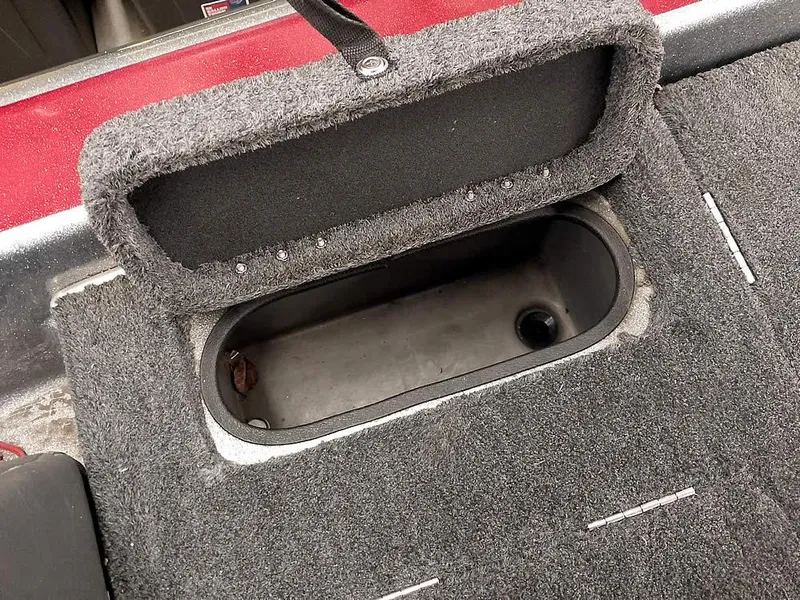 Slide: The Image of Open storage compartment in 1999 Champion 171 boat with carpeted interior. - 31