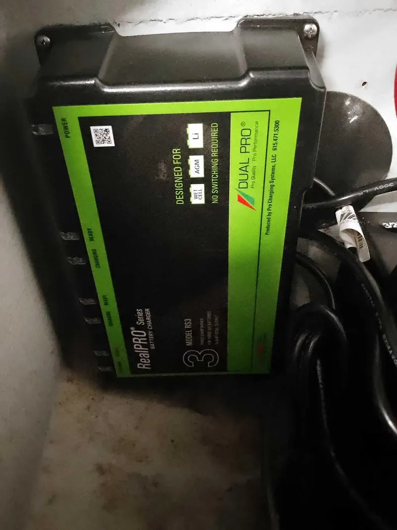 Slide: The Image of Battery charger with green label, Dual Pro brand, mounted on a wall. - 33