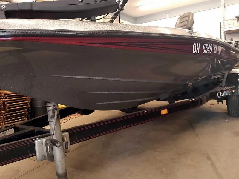 Slide: The Image of 1999 Champion 171 boat on trailer in garage, side view. - 5
