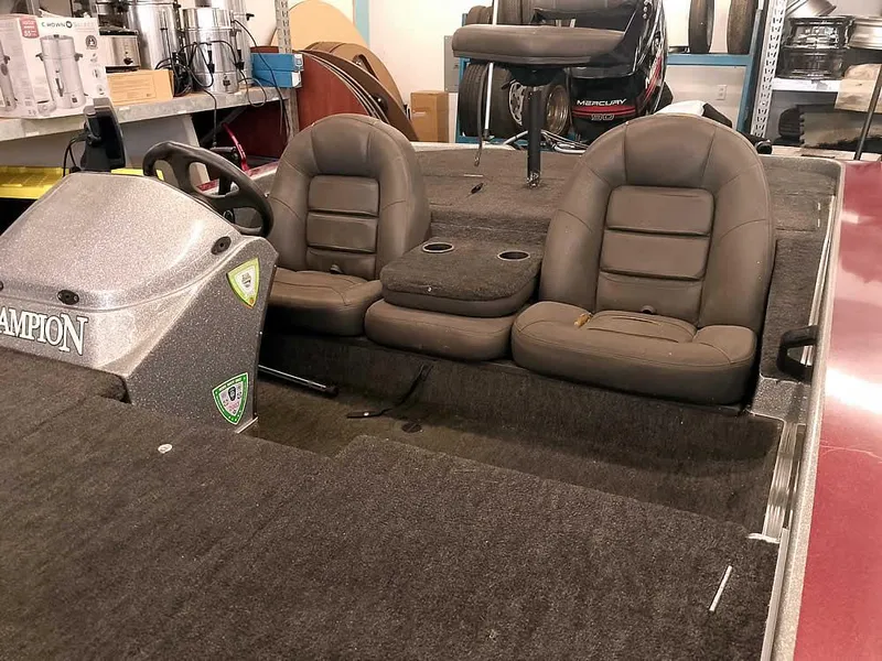 Slide: The Image of 1999 Champion 171 boat interior with dual seats and steering console. - 8