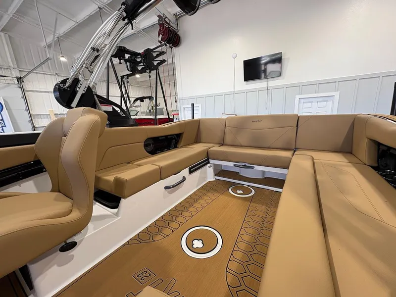 Slide: The Image of 2025 MasterCraft NXT23 boat interior with tan seating and modern design. - 11