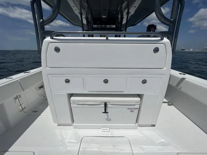 Slide: The Image of 2024 Invincible 43 Open Fisherman boat interior with storage compartments on open water. - 10