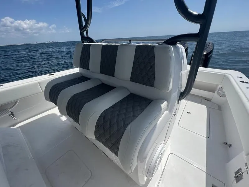 Slide: The Image of 2024 Invincible 43 Open Fisherman boat seating with ocean backdrop. - 12