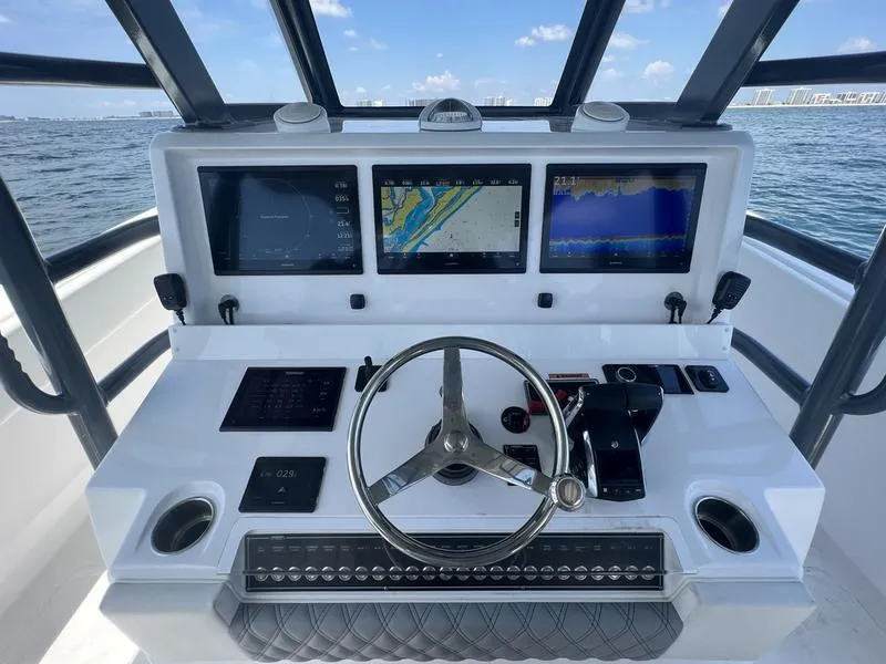 Slide: The Image of 2024 Invincible 43 Open Fisherman helm with advanced navigation displays and steering wheel. - 15