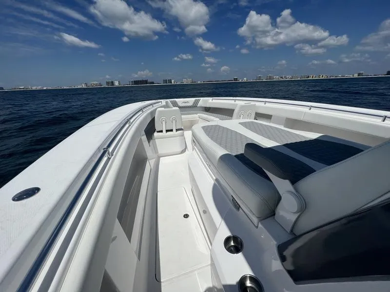 Slide: The Image of 2024 Invincible 43 Open Fisherman boat on open water, featuring sleek seating and clear skies. - 17