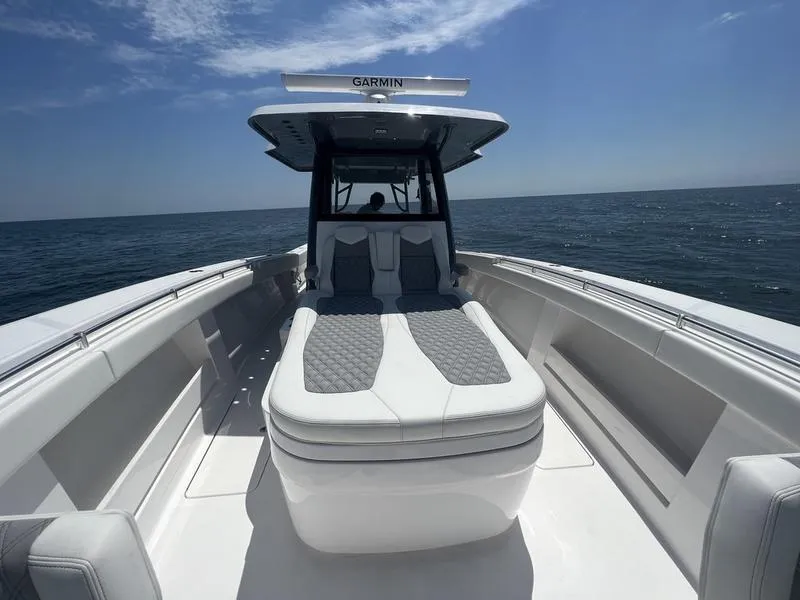 Slide: The Image of 2024 Invincible 43 Open Fisherman boat with cushioned seating, cruising on open water. - 19