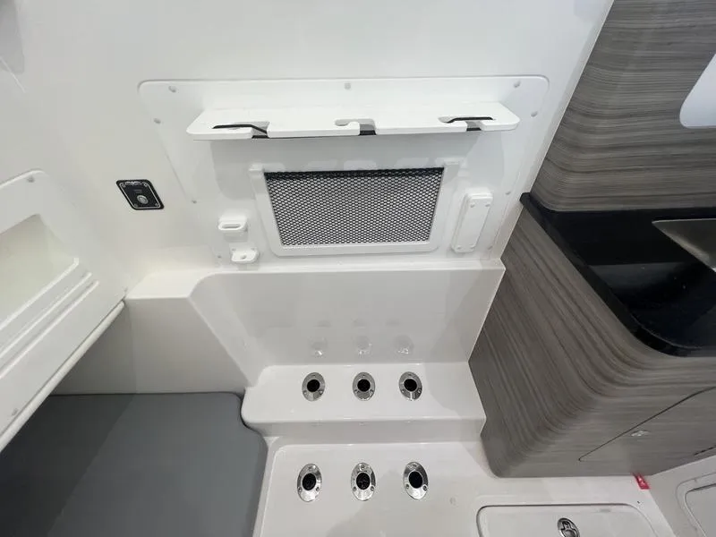 Slide: The Image of 2024 Invincible 43 Open Fisherman interior, featuring storage compartments and modern design elements. - 27