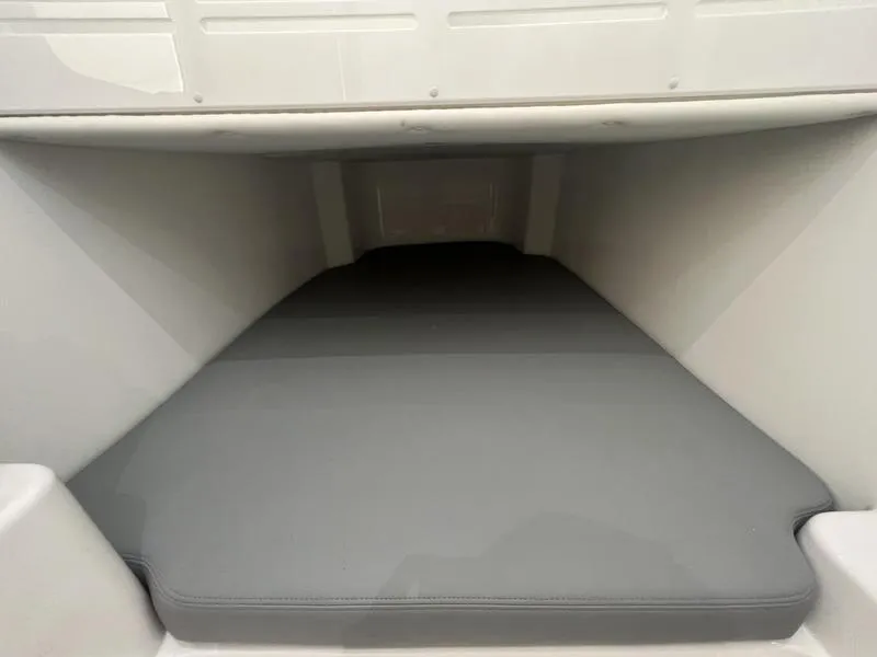 Slide: The Image of 2024 Invincible 43 Open Fisherman cabin interior with gray cushioned bed. - 28