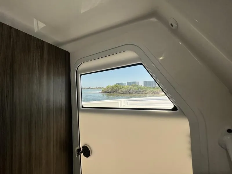 Slide: The Image of Interior view of 2024 Invincible 43 Open Fisherman boat with window overlooking water. - 30
