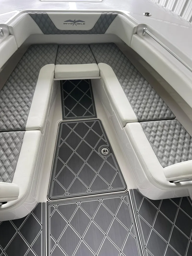 Slide: The Image of 2024 Invincible 43 Open Fisherman boat interior with diamond-patterned seating and flooring. - 32