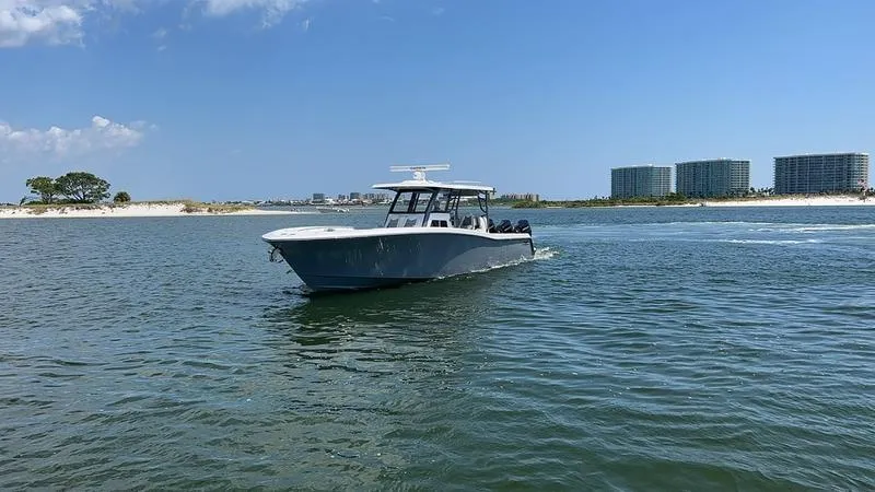 Slide: The Image of 2024 Invincible 43 Open Fisherman boat cruising on a sunny day near the shore. - 4