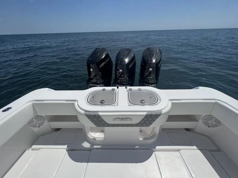 Slide: The Image of 2024 Invincible 43 Open Fisherman boat with triple Mercury engines on open sea. - 7