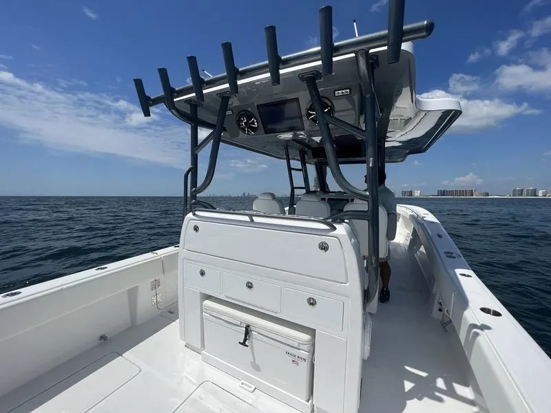 Slide: The Image of 2024 Invincible 43 Open Fisherman boat on open water, featuring a spacious deck and modern console. - 9