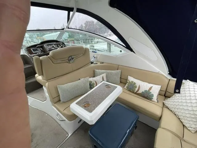 Slide: The Image of Interior of 2012 Cruisers Yachts 380 Express with beige seating and decorative pillows. - 13