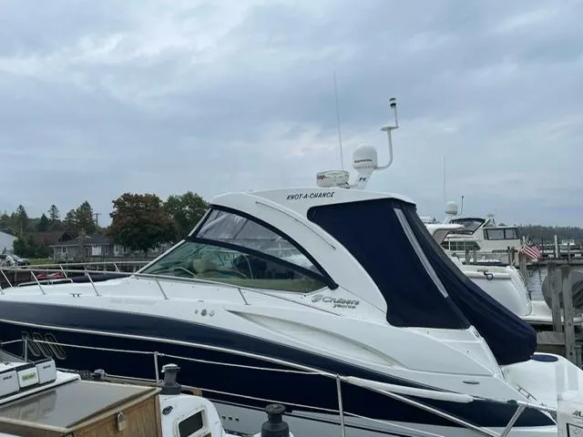 Slide: The Image of 2012 Cruisers Yachts 380 Express docked, featuring sleek design and navy canopy. - 16